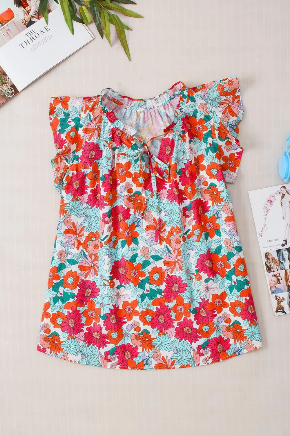 Hazel Blues® |  Ruffled Printed Tie Neck Cap Sleeve Blouse